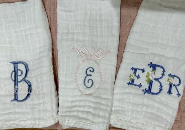 Three towels with the letters e, e and e on them.