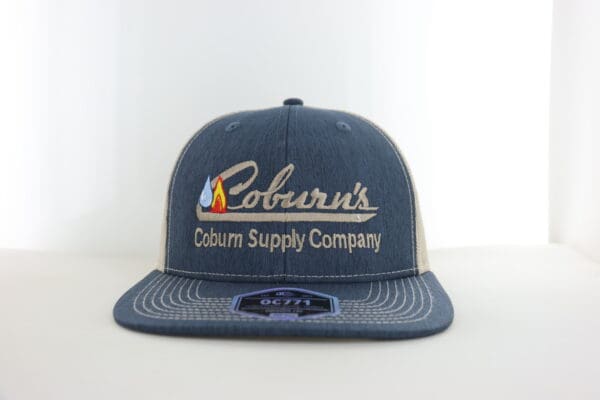 A blue hat with the company name coburn supply company.