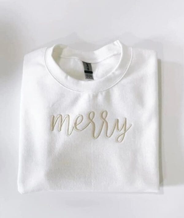 A white shirt with the word " merry ".