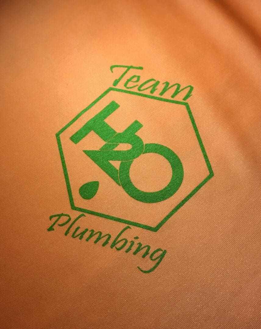 A close up of the logo for team ho plumbing