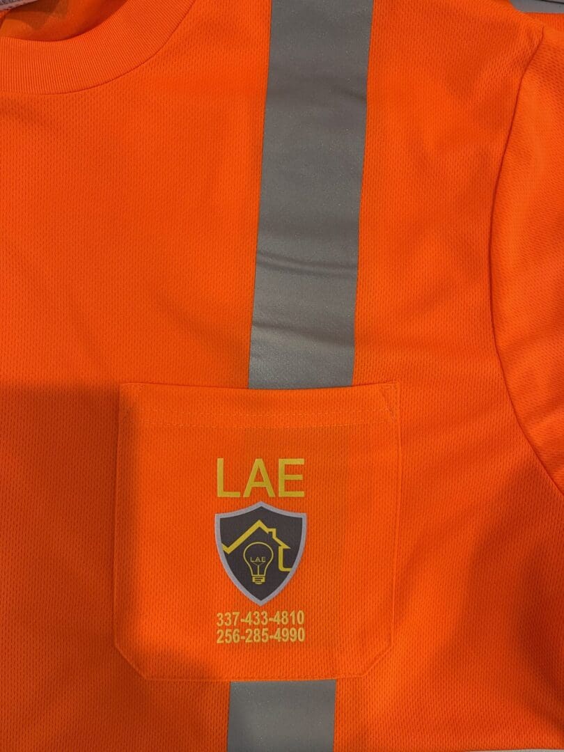 A close up of the front pocket on an orange jacket.