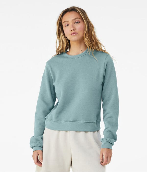 A woman wearing a light blue sweatshirt.