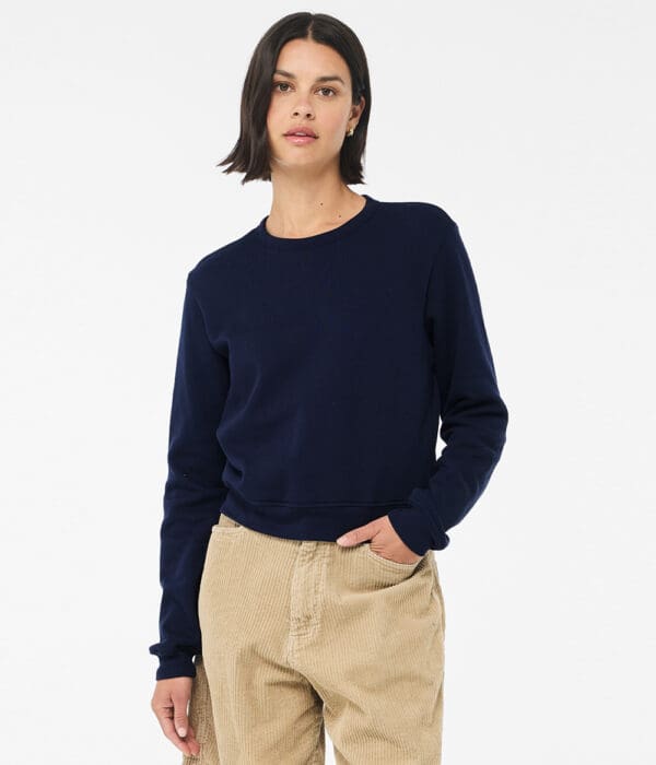 A woman wearing khaki pants and a navy blue sweater.