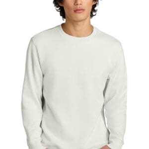 A man wearing white long sleeve shirt and black hat.