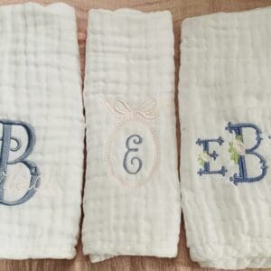 Three towels with the letters e, b and e on them.