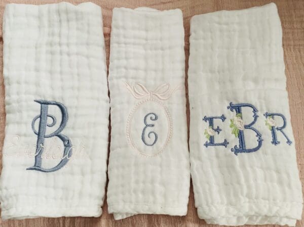 Three towels with the letters e, b and e on them.