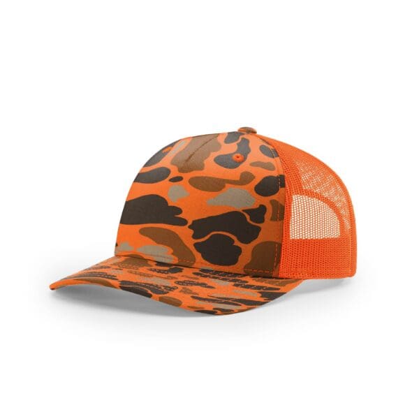 A hat that is orange and has an animal print.