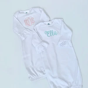 A white onesie with the name ella and an embroidered monogram.