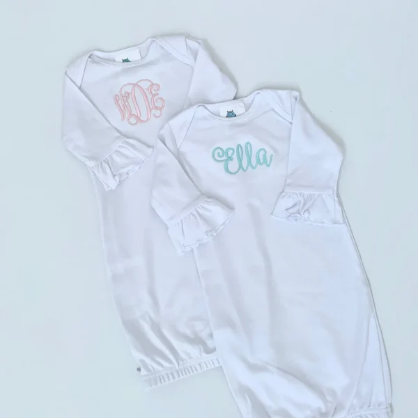 A white onesie with the name ella and an embroidered monogram.