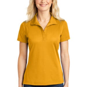 A woman wearing an orange polo shirt.