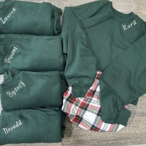 Personalized green family sweatshirts and pajamas.