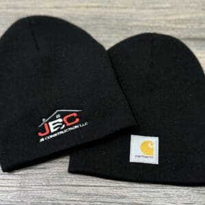 Two black embroidered knit beanies.