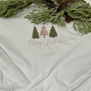 White sweatshirt: Merry Christmas trees.